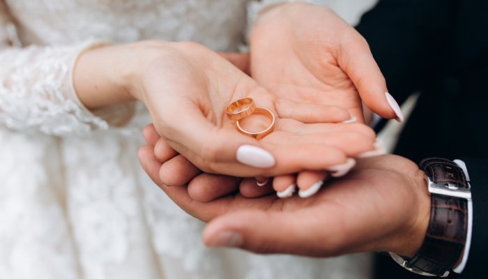 Groom holds bride s hands where are two wedding rings www.talbothotelclonmel.ie